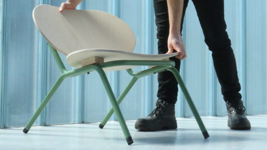 Person adjusting a plywood chair with green legs