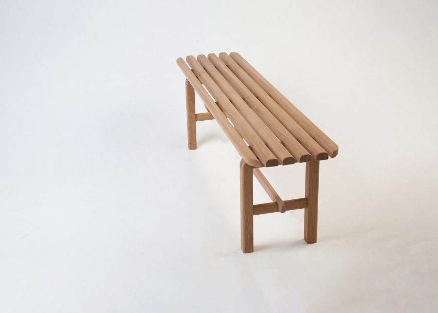 Photograph of a wooden bench on a white backdrop