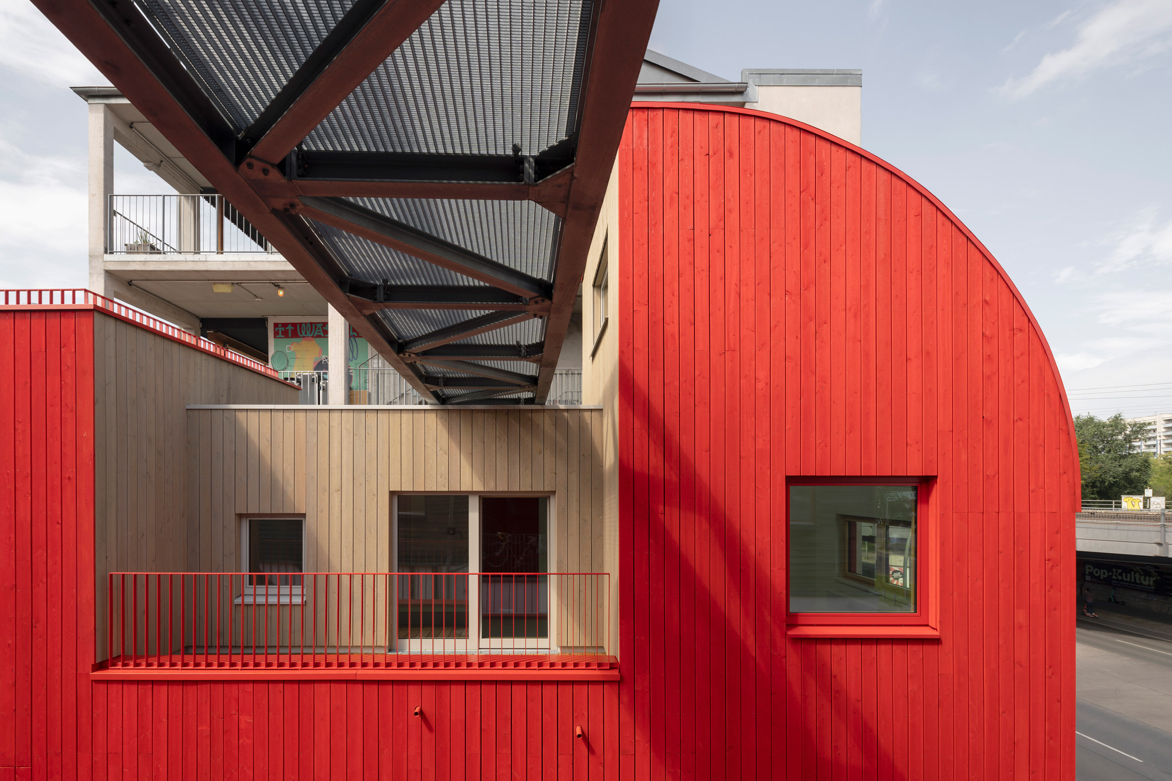 Red wood cladding on the Haus 2+ office building by Office ParkScheerbarth