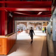 Foyer with red steel structure at Aviva Studios by OMA