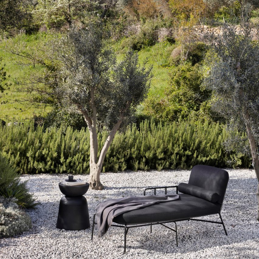 Black daybed on gravel drive