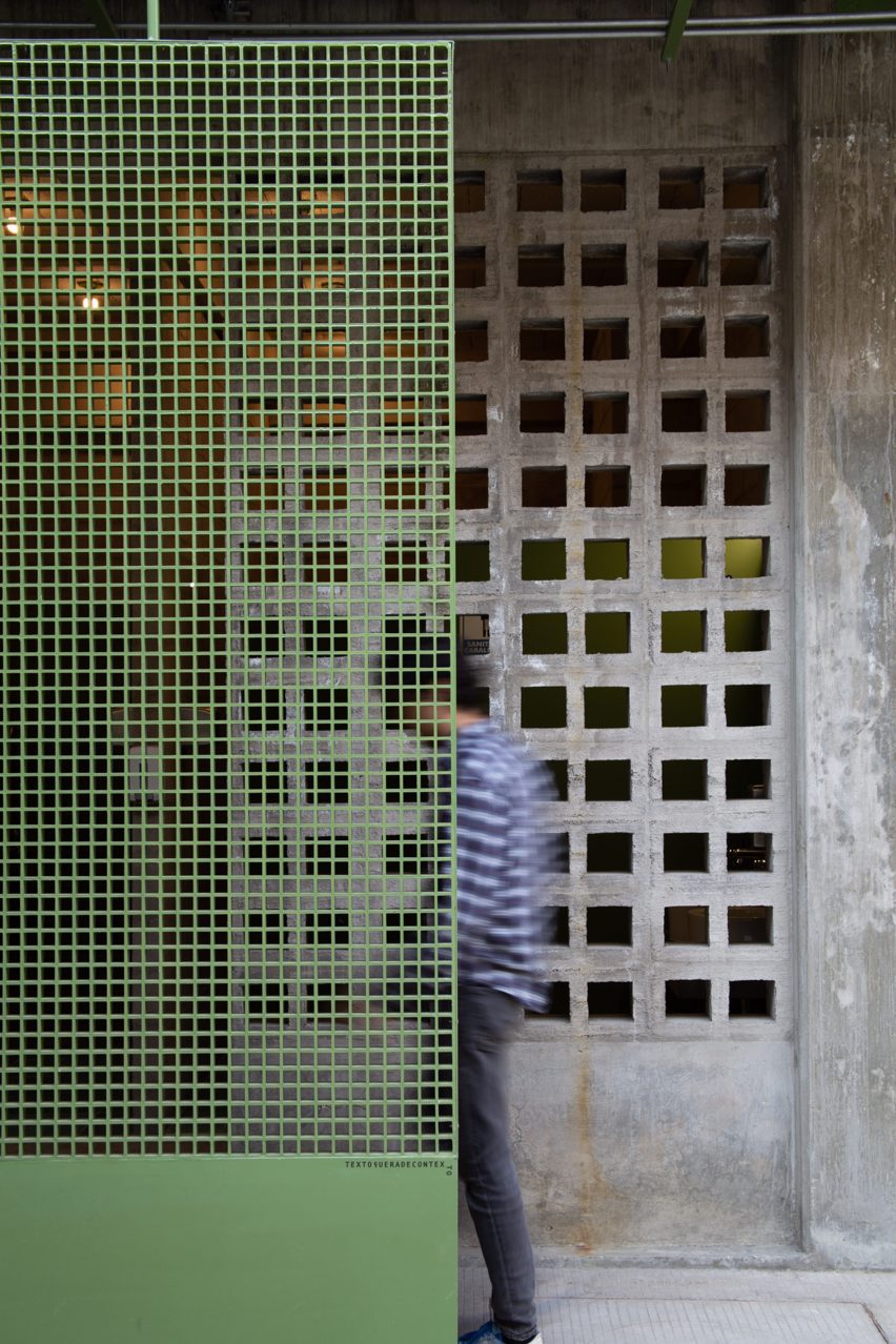 Green metal screen with concrete breeze blocks