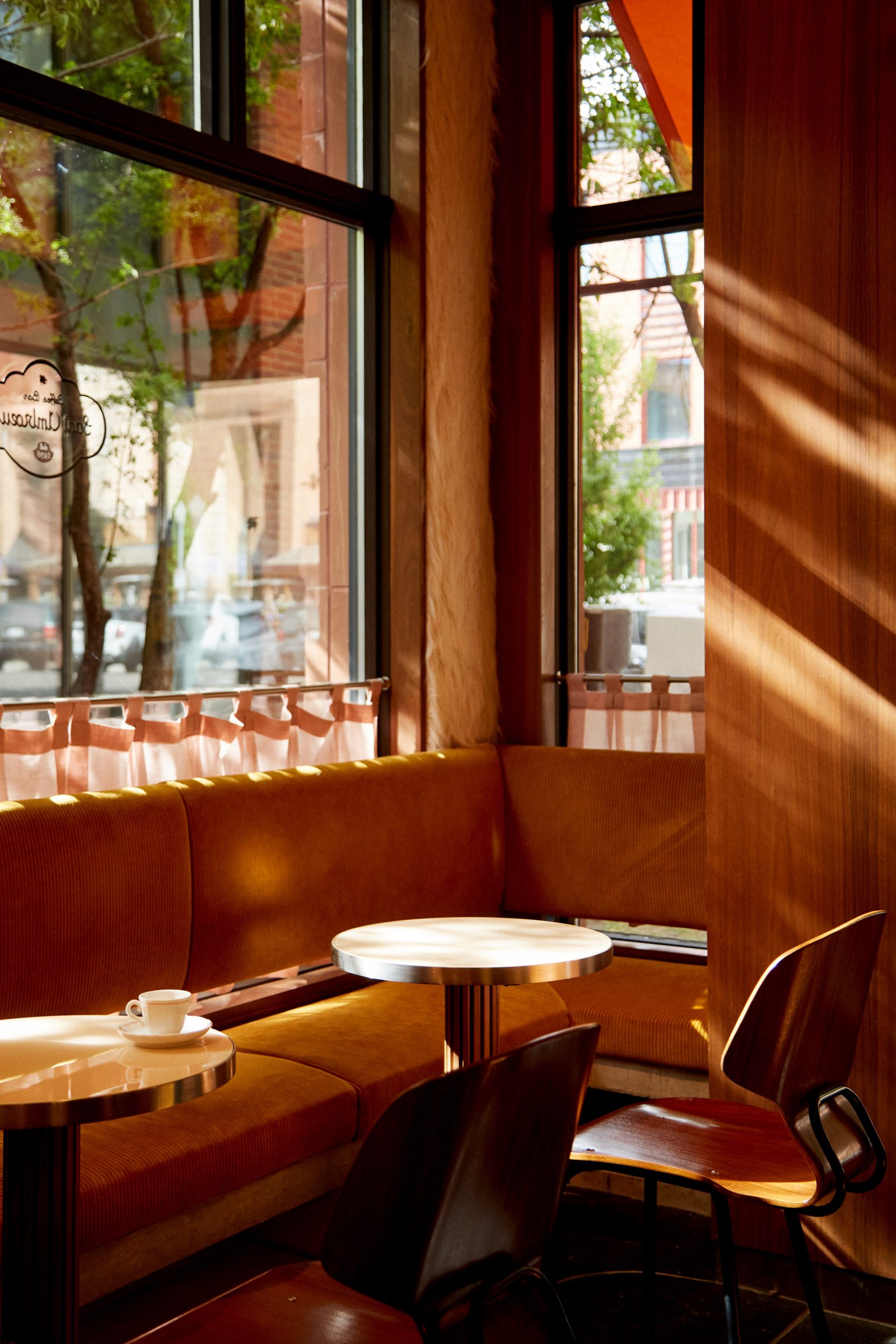 Seating in the cafe window with shadows patterning the walls
