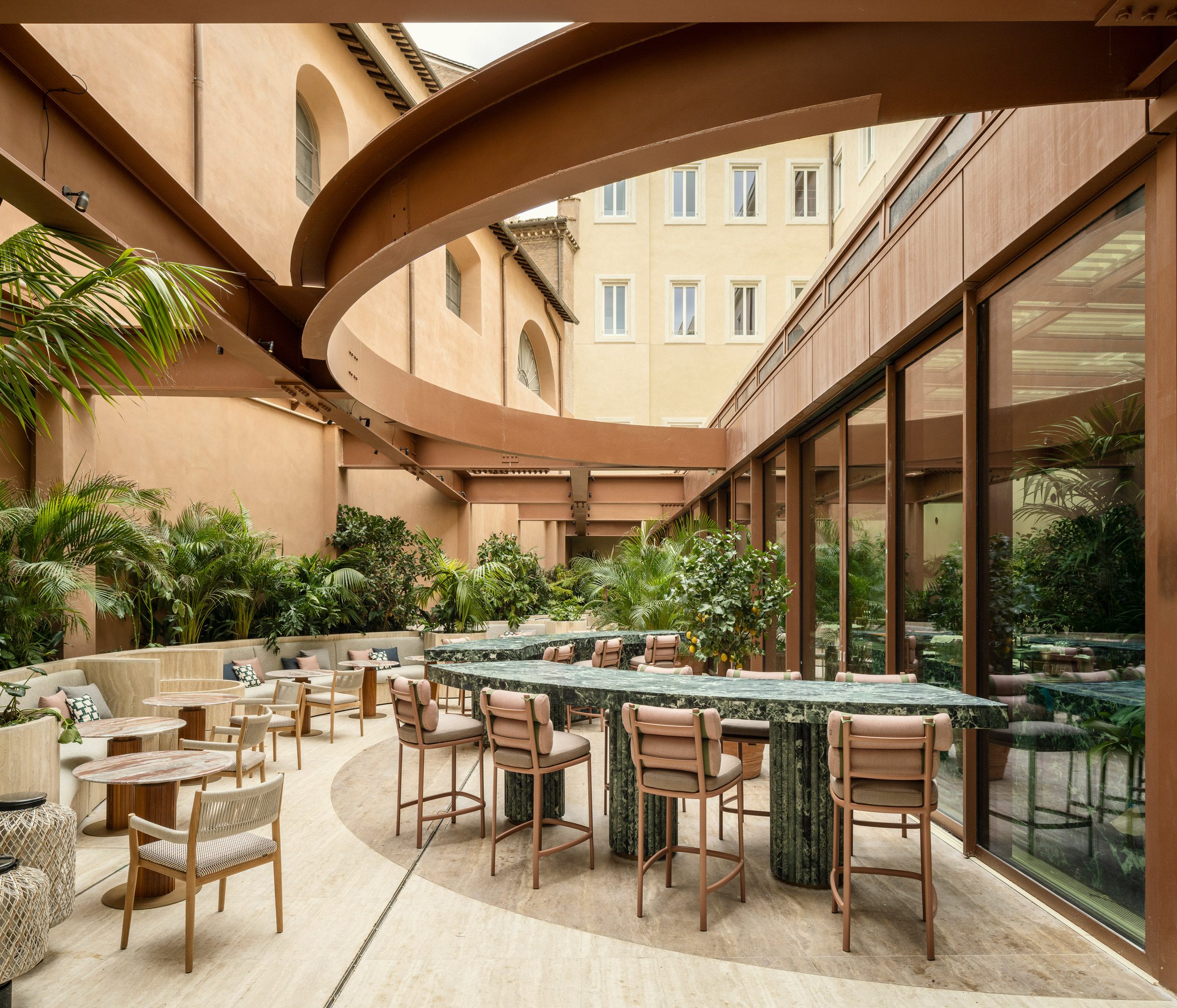 Courtyard with green marble bar counter below steelwork in Six Senses Rome hotel by Patricia Urquiola