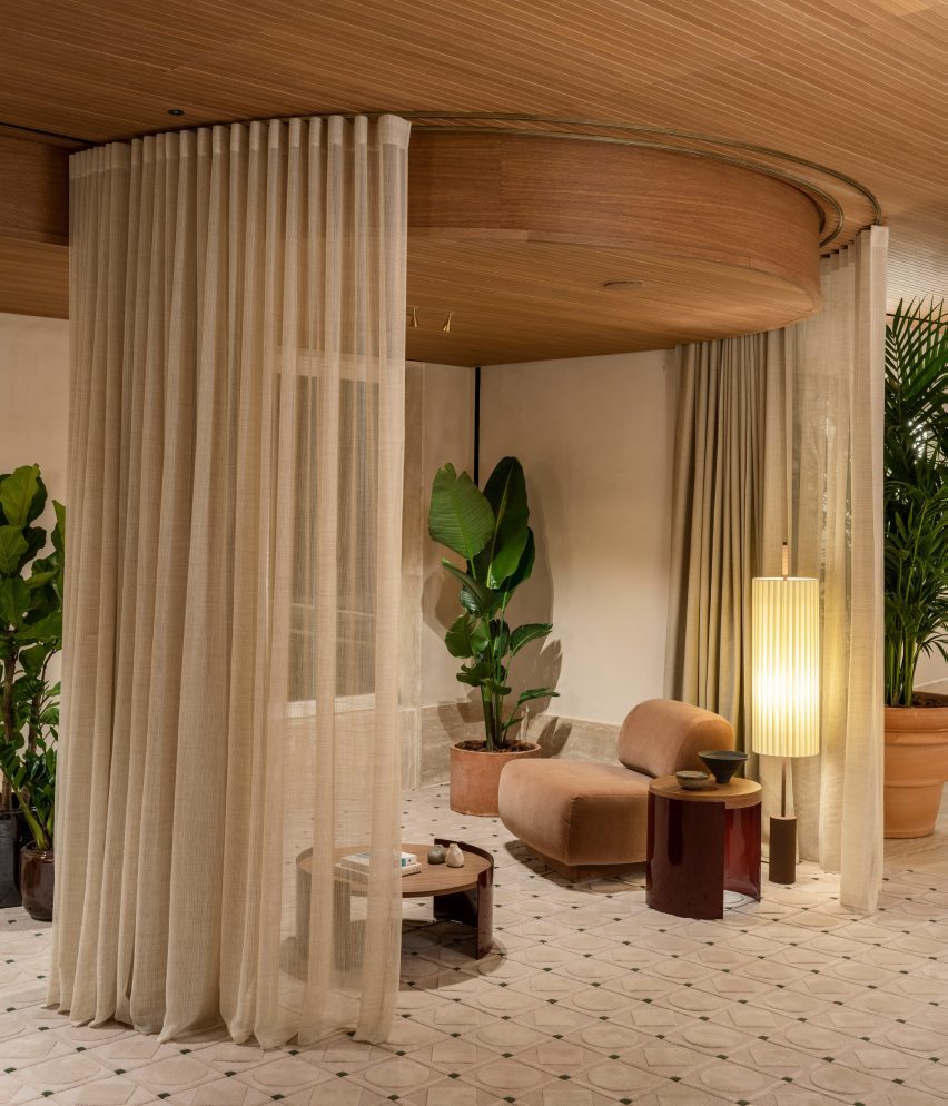 Spa waiting area featuring seating within sheer curtain enclosures
