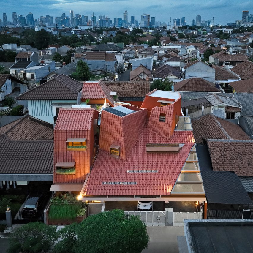 Distracted House with an angular red-tiled roof by Ismail Solehudin Architecture