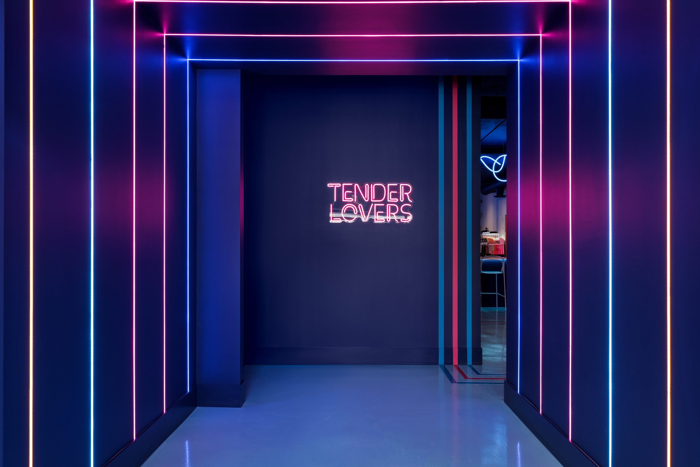 Midnight blue vestibule with neon strips across the walls and ceiling