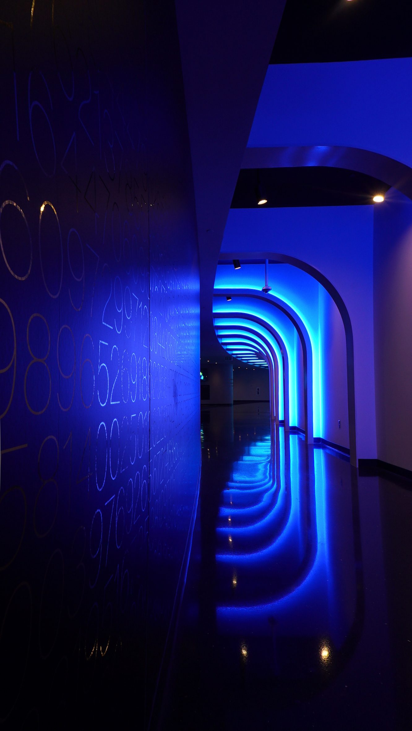 Dark tunnel with arches illuminated with blue light