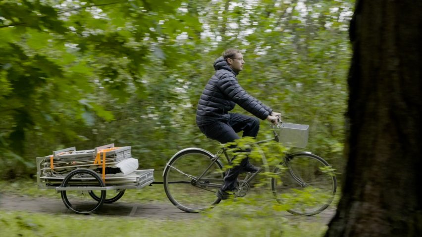 Trunk Bunk portable treehouse by Henry K Wein being towed by bicycle