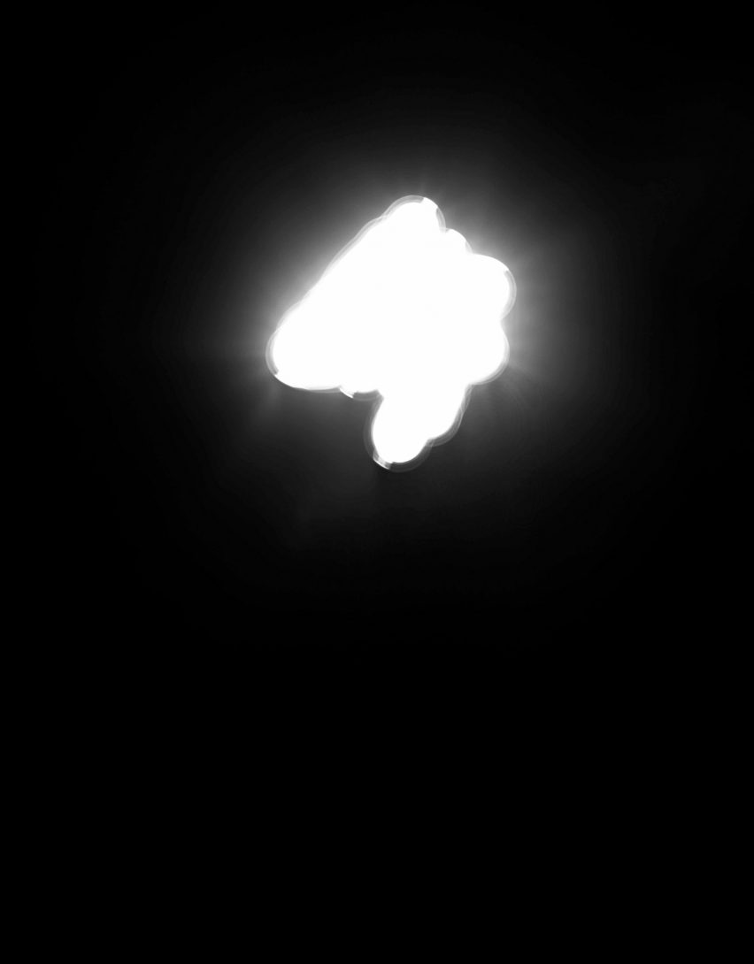 Photo of a bright white light on a black background in an abstract shape