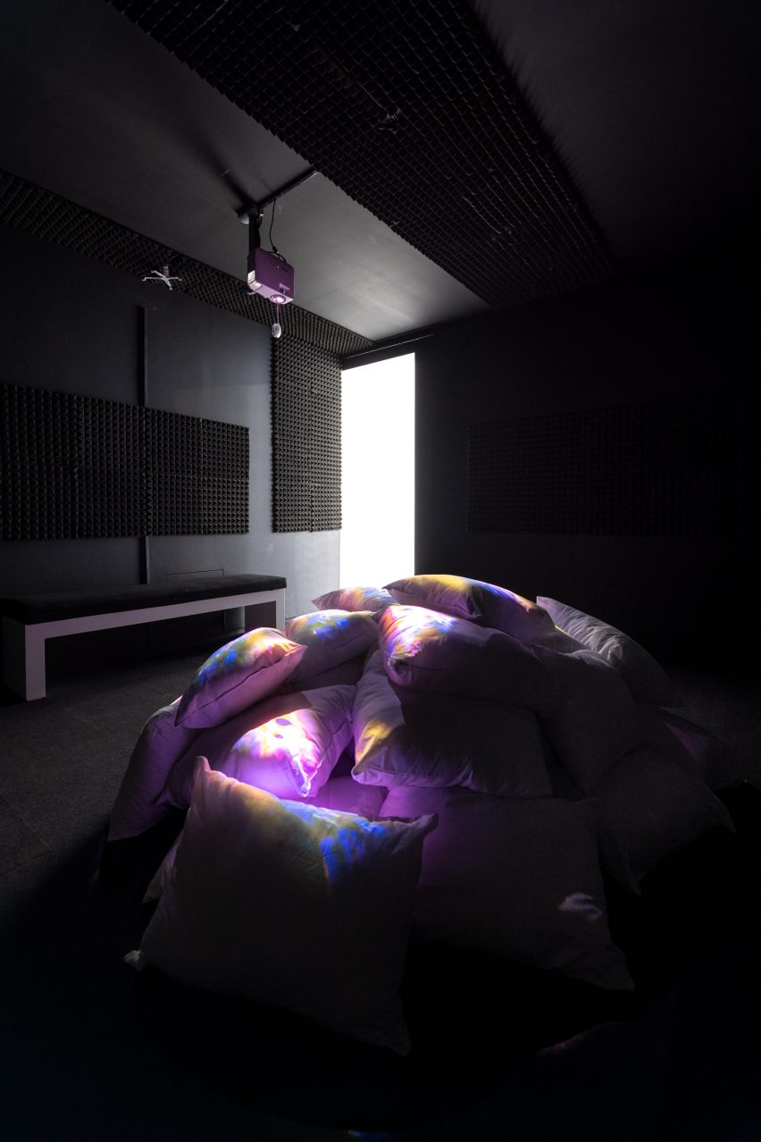 Photo of a pile of pillows lit by a ceiling-mounted projector