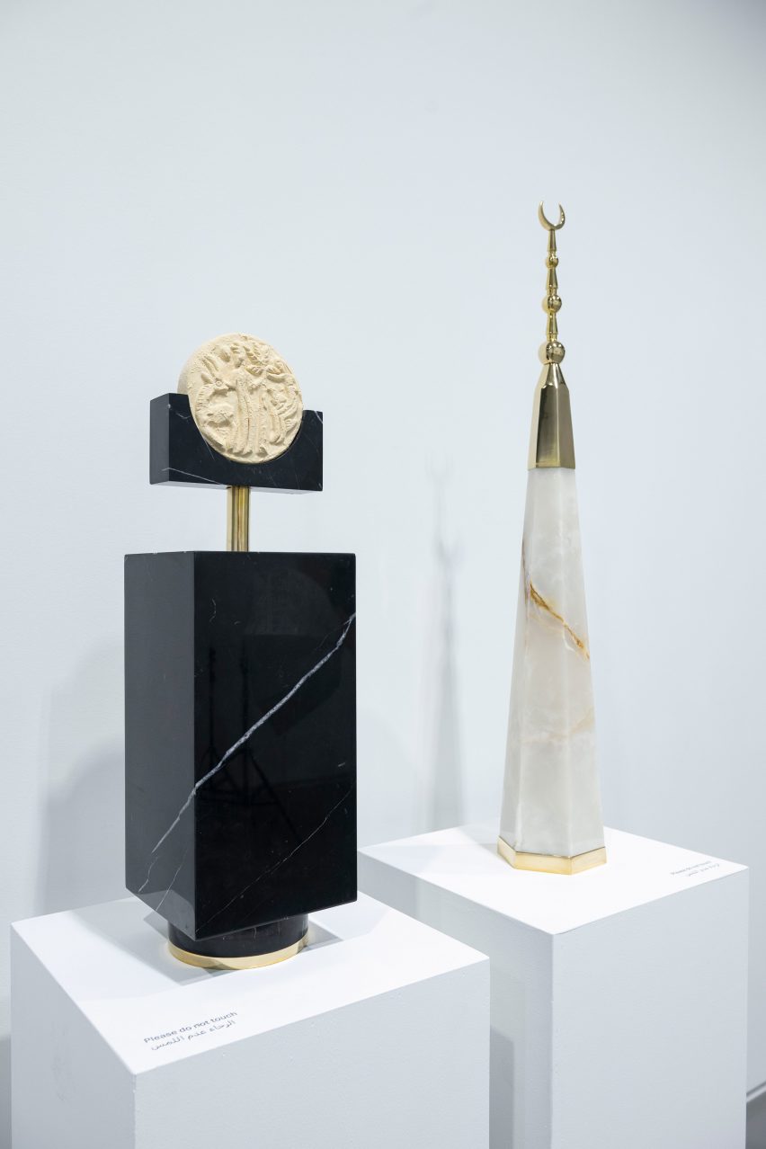 Two objects on plinths made from metal and marble