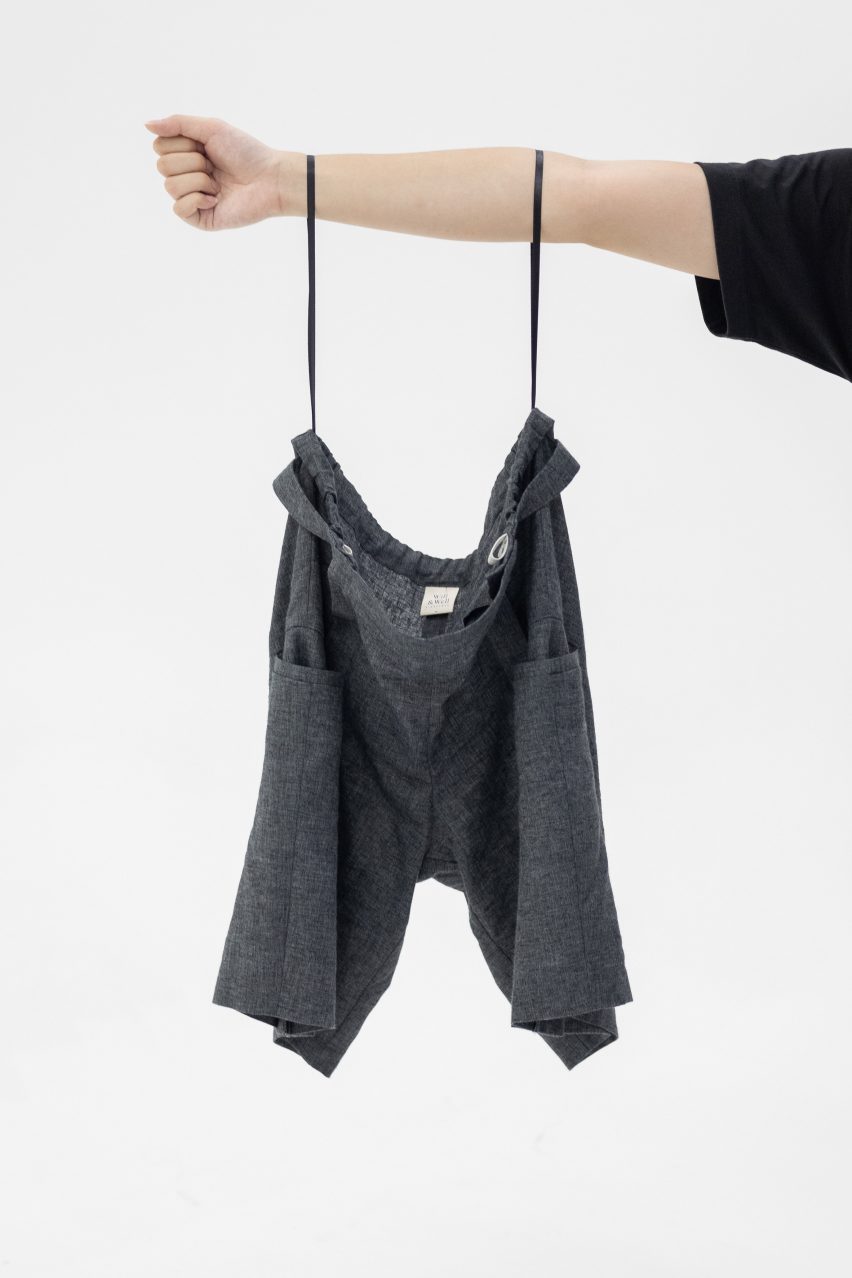 Photo of Will & Well's Adjustable Shorts hanging from a person's arms by the HangLoops on the waistband