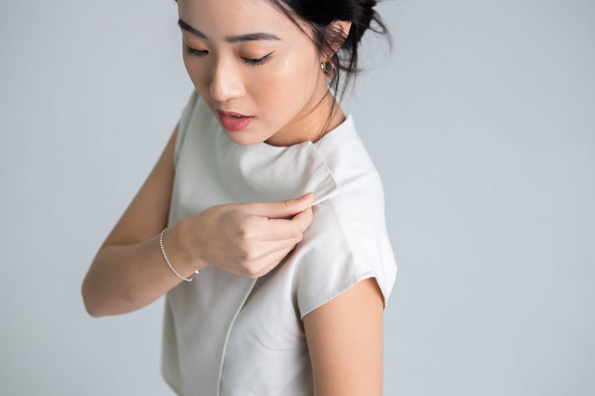 Photo of a model wearing Will & Well's Two-Way blouse, with a close-up of the velcro fastening at the neck line
