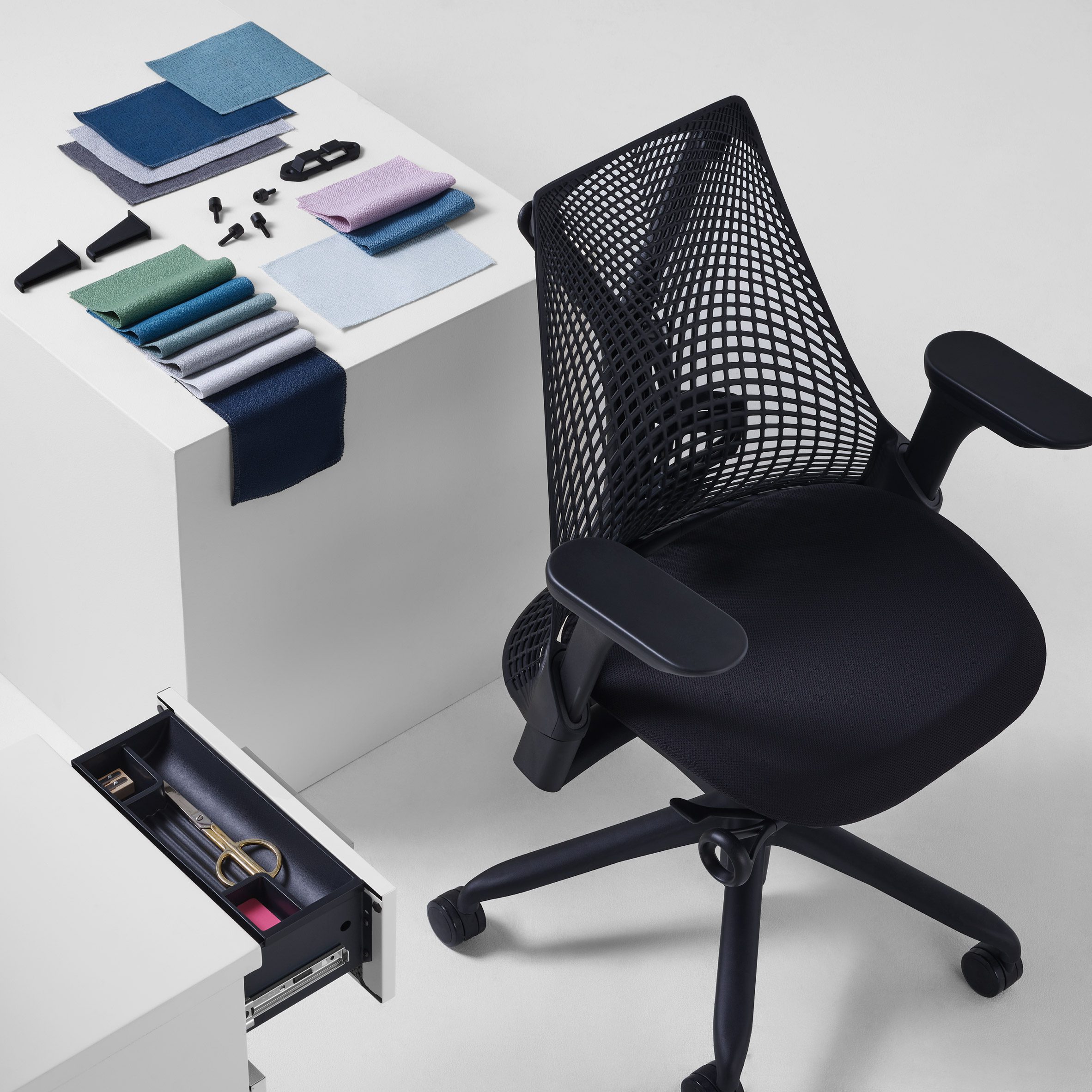 Herman Miller and Yves Béhar's Sayl chair in black photographer in an abstracted office setting