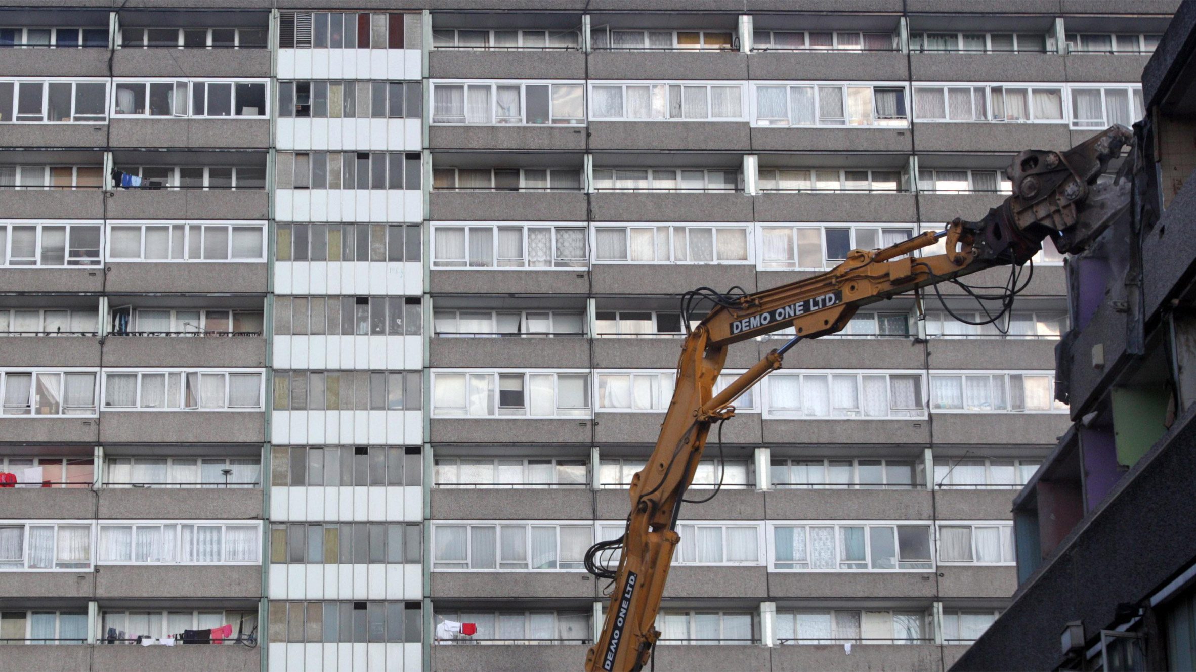 A crane tearing down buildings on the Aylesbury Estate in London