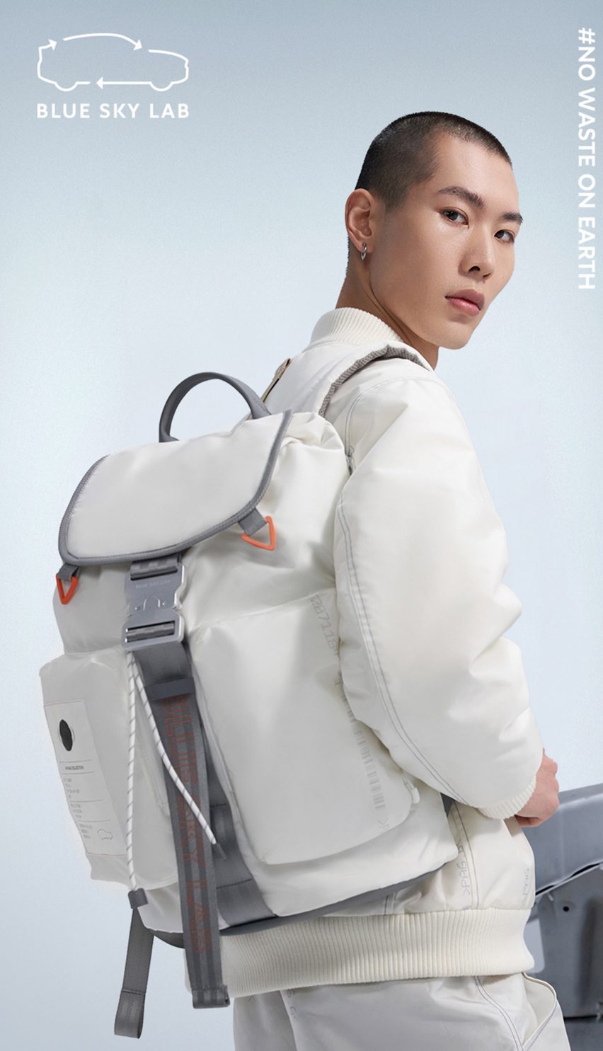 Male model carrying a white backpack by Blue Sky Lab