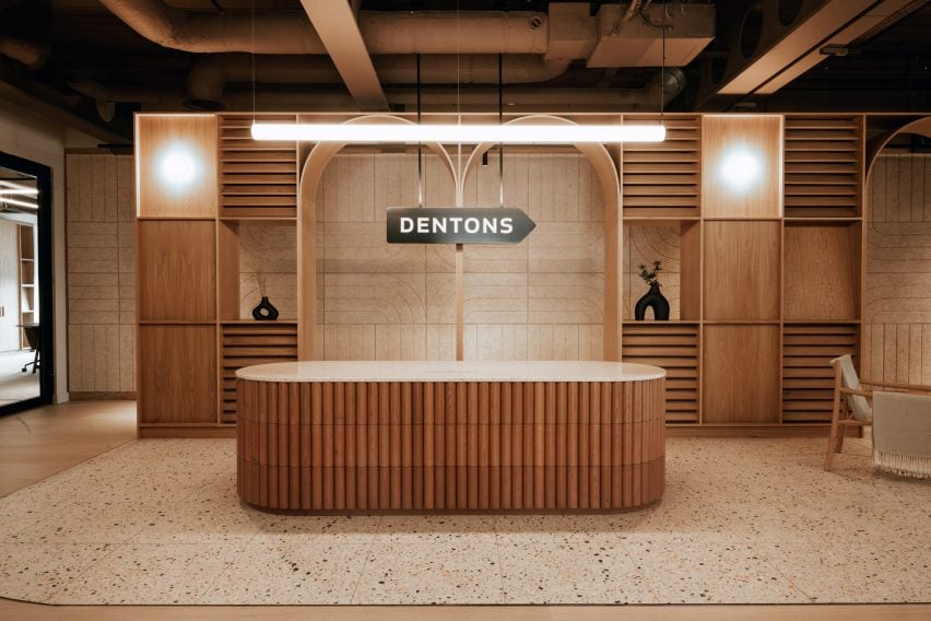 Timber welcome desk at Dentons law firm by 'Kin
