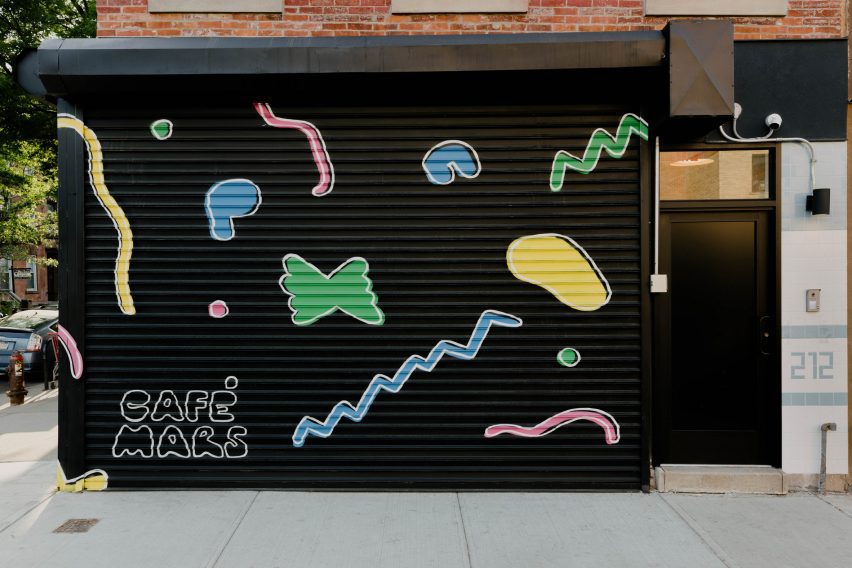 Black roller shutter covered with colourful illustrations of pasta shapes