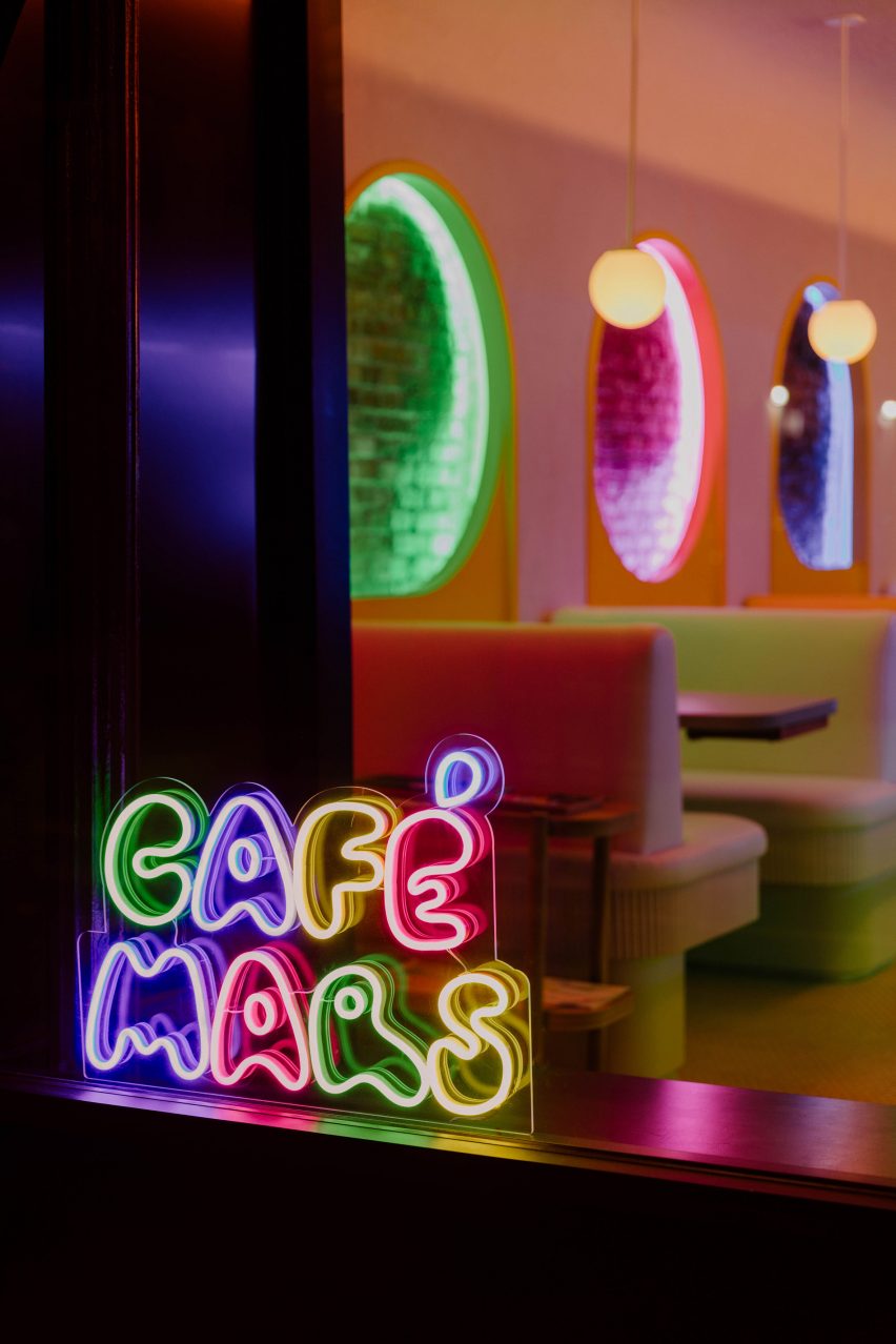 A neon version of the Cafe Mars logo placed in a window