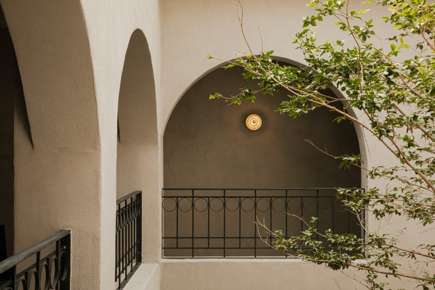 Arched openings with black cast-iron handrails