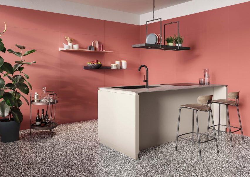 Kitchen with red-pink coloured tiled walls