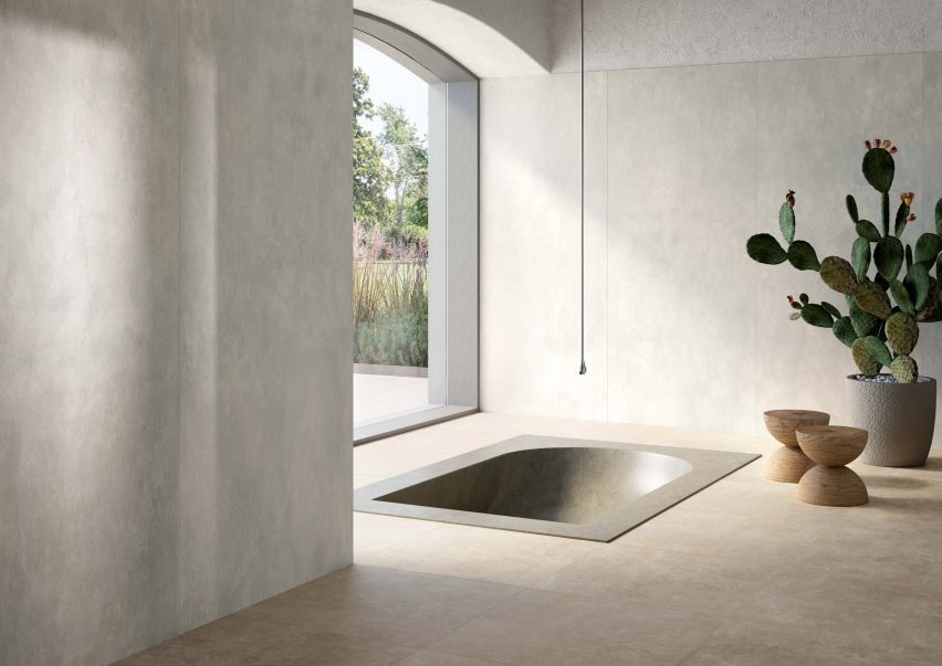 Sunken bath in grey-tiled bathroom