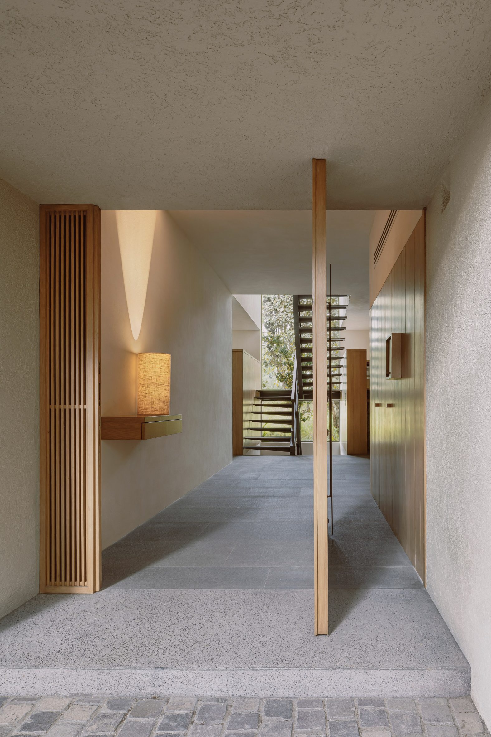 Wooden pivot door at Casa Cielo by COA Arquitectura