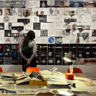 a person looking at a wall of sketches and drawings
