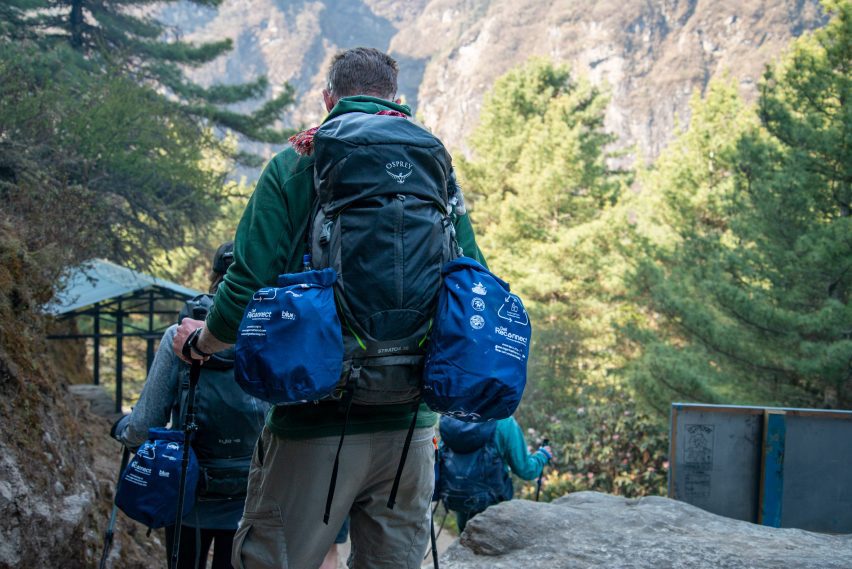 Hiker carries bags of trash in From The Himalayas project by Super Local