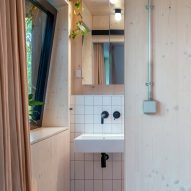 Bathroom with plywood walls and white tiled splash backs