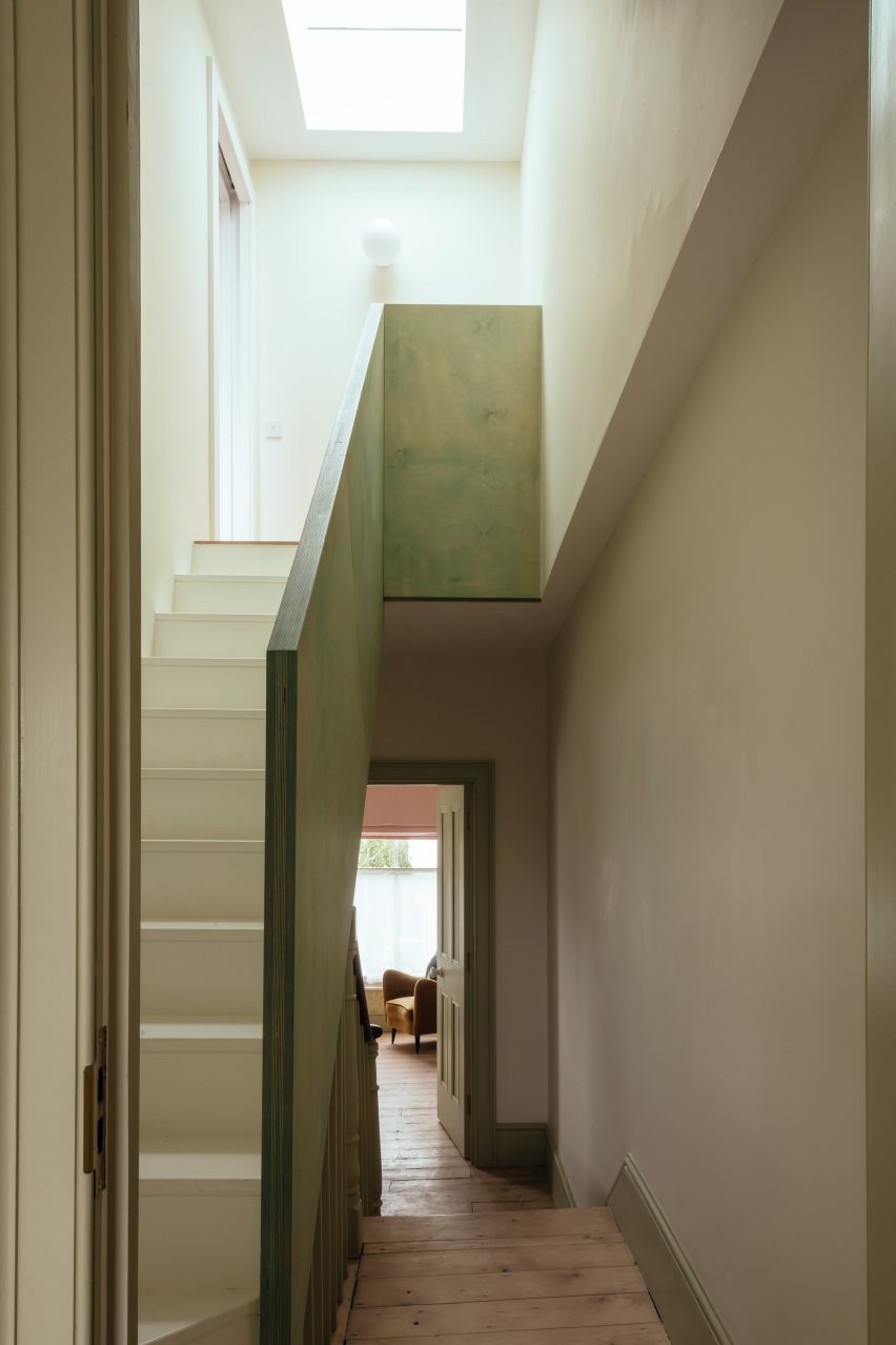 Green plywood staircase leads to modern loft conversion