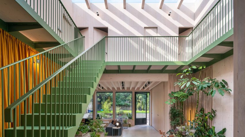 Atrium with green staircase at Green House by Hayhurst and Co