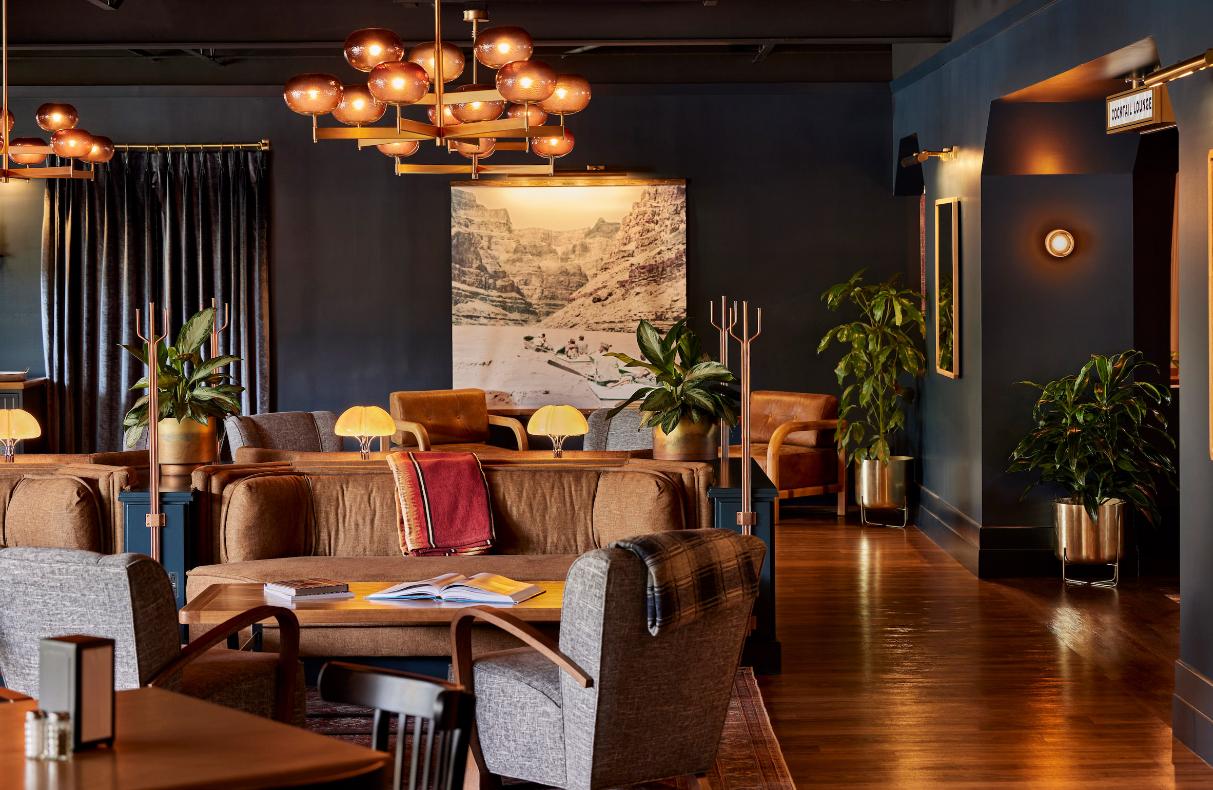 Hotel lounge with dark blue walls and amber lighting
