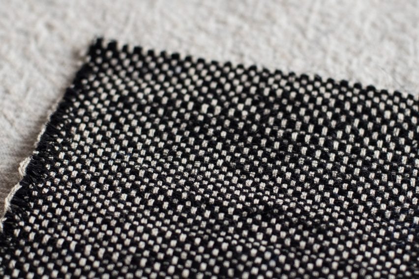 Photo of a piece of black and white thick woven fabric lying flat on a surface