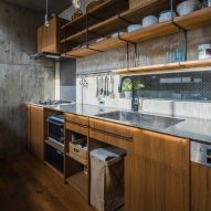 Kitchen with wood units in a concrete home
