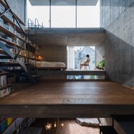 Concrete home interior in Japan with a bookshelf wall
