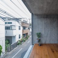 Floor-to-ceiling window in a concrete home overlooking a street