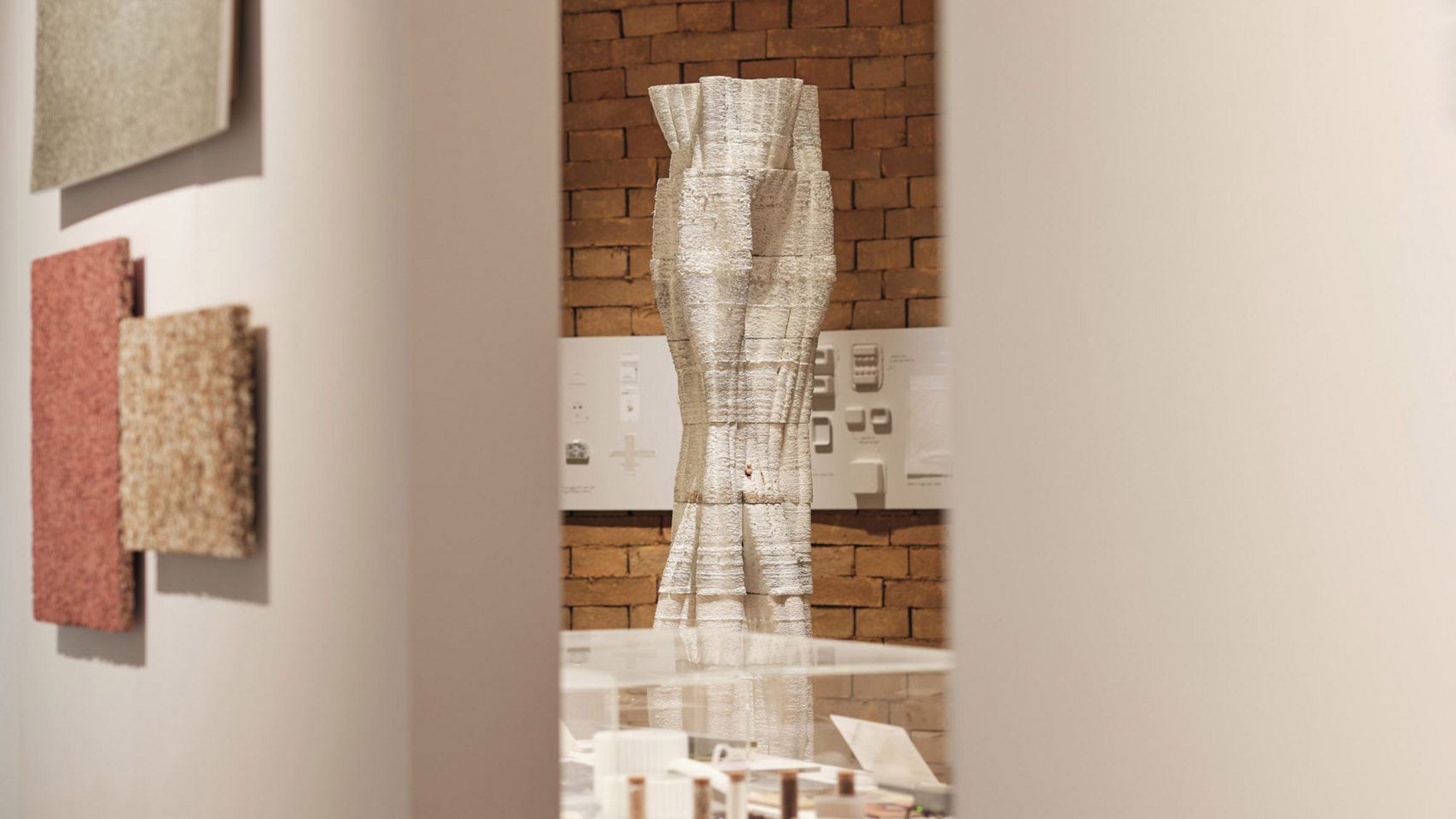 Photo of Blast Studio's Tree Column made of 3D-printed mycelium set within an exhibition