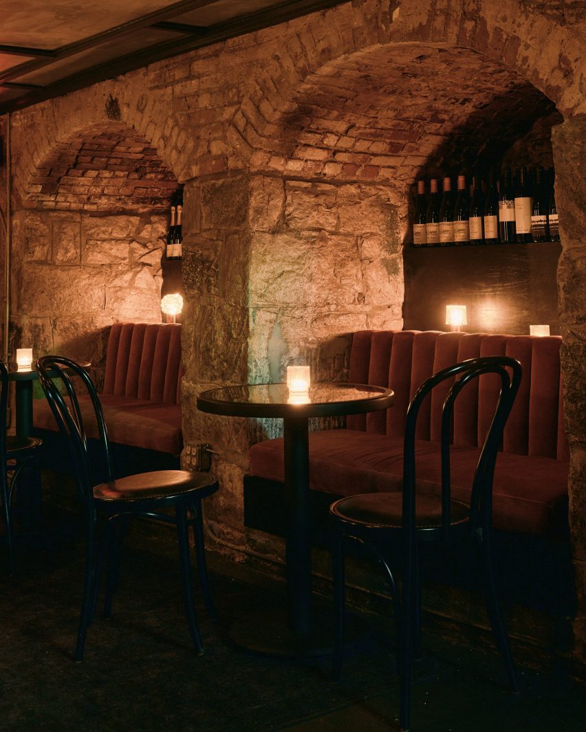 Banquettes built into stone arches with low lighting