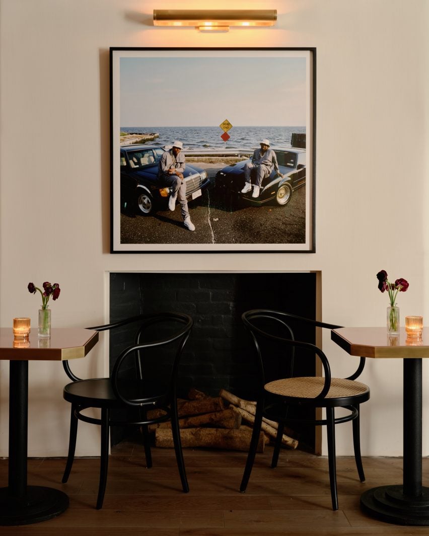 Fireplace with a photo above and two chairs in front