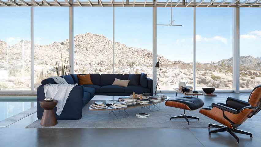 Furniture in living room with large windows in desert landscape