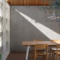 Dining room with a concrete wall and brick flooring