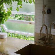 Kitchen sink next to open frosted windows