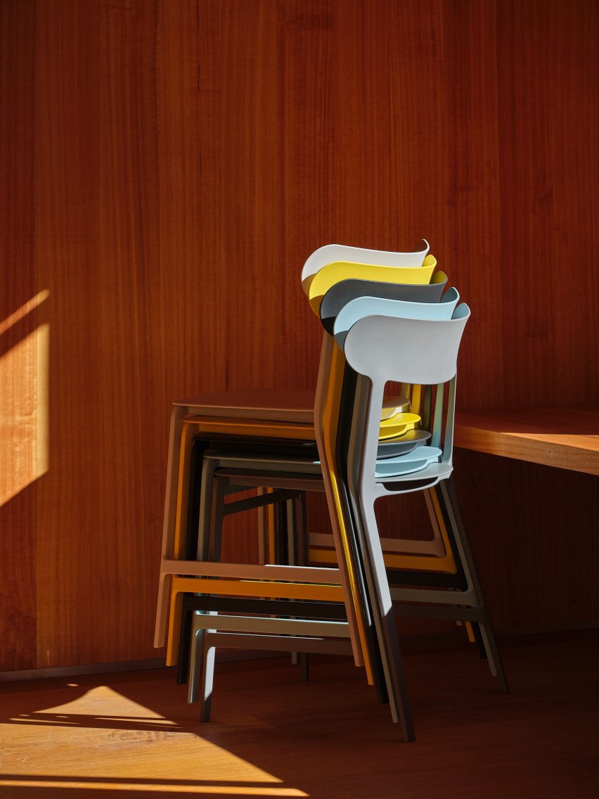 Stack of different coloured Lightly chairs by Formway for Noho