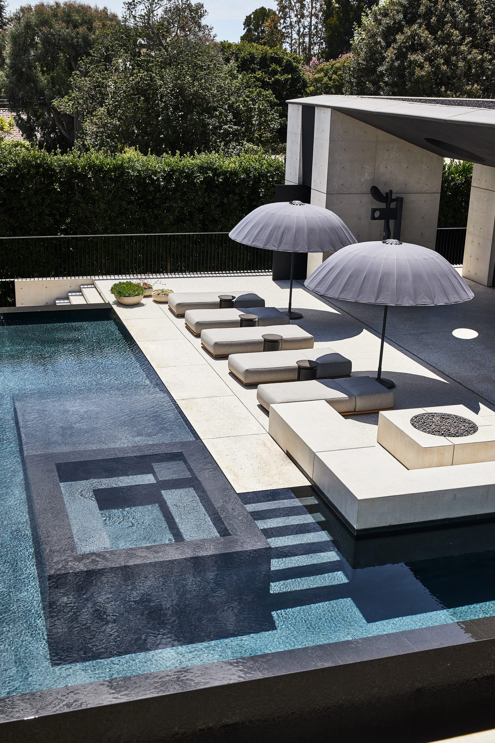 Swimming pool and terrace in front of a concrete pool house