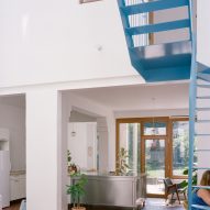 Blue metal staircase in a double-height atrium