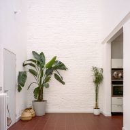Entryway with white brick walls and tiled flooring