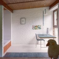 Study room with white brick walls and timber ceilings
