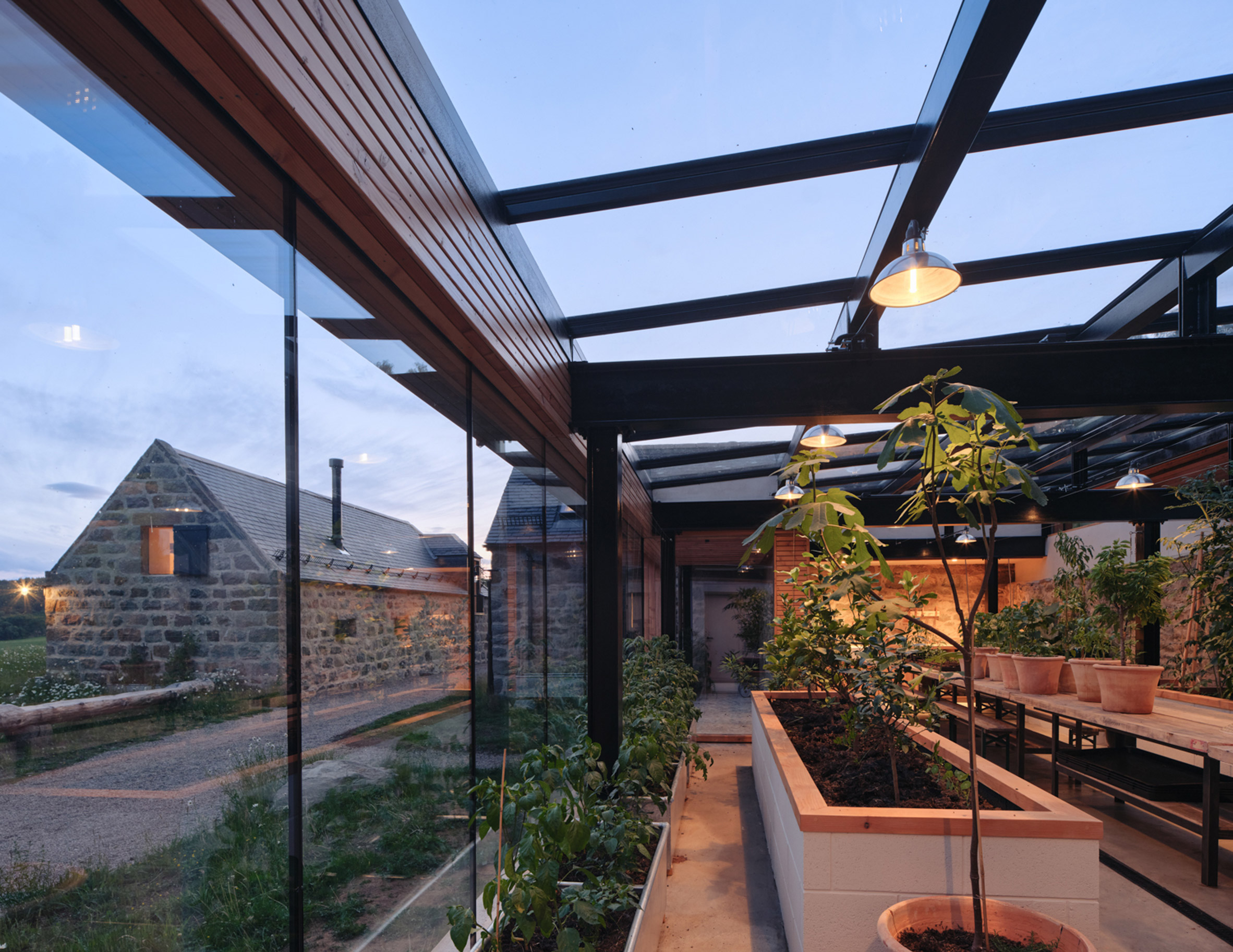 A glasshouse with a glazed wall extension
